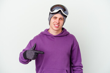 Young man holding a snowboard board isolated on white background person pointing by hand to a shirt copy space, proud and confident