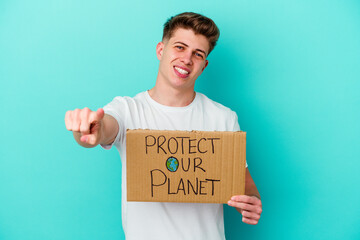 Young caucasian man holding a protect our planet placard isolated on blue background