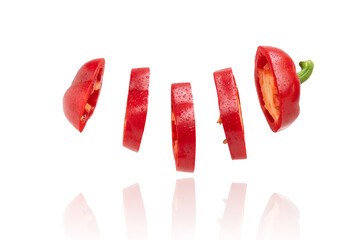 Creative concept with flying red bell peppers, sliced ​​bell peppers. isolated on white background