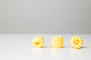 Crispy Corn rings salty snacks. Fast food or junk food snacks unhealthy concept.