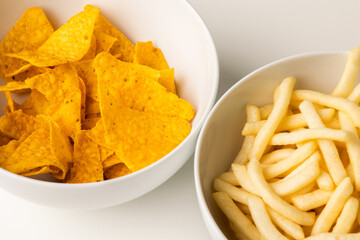 Crispy mexican nachos chips and French fries salty.Snacks Fast food or junk food snacks unhealthy concept.