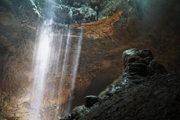 Fototapeta na wymiar Beautiful ray of light inside Jomblang Cave, Yogyakarta, Indonesia