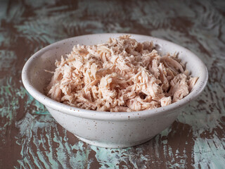 Finely chopped chicken fillet in a deep ceramic plate close-up