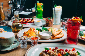 Various breakfast dishes are served on the table in the restaurant.