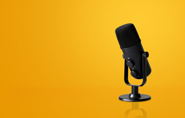 microphone on yellow background with soft-focus and over light in the background. space for text.
