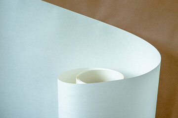 Roll of white paper on a brown background.