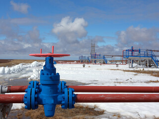 Ecology. Gas industry. Beautiful white clouds on a background of a gas valve