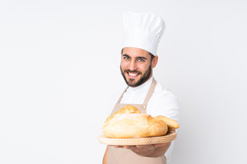 Male baker holding a table with several breads isolated on white background