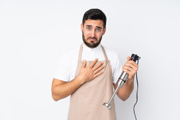 Man using hand blender isolated on white background pleading