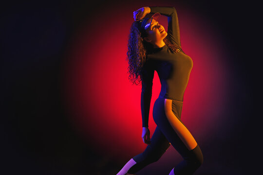 Full length image of 80's Fashion woman over pink background. Beautiful athletic girl in 80s style