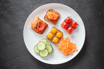 Lovely and tasty vegetarian sandwiches on a white plate from above