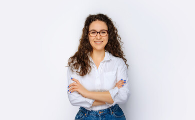 Happy young business woman posing isolated over grey wall background.