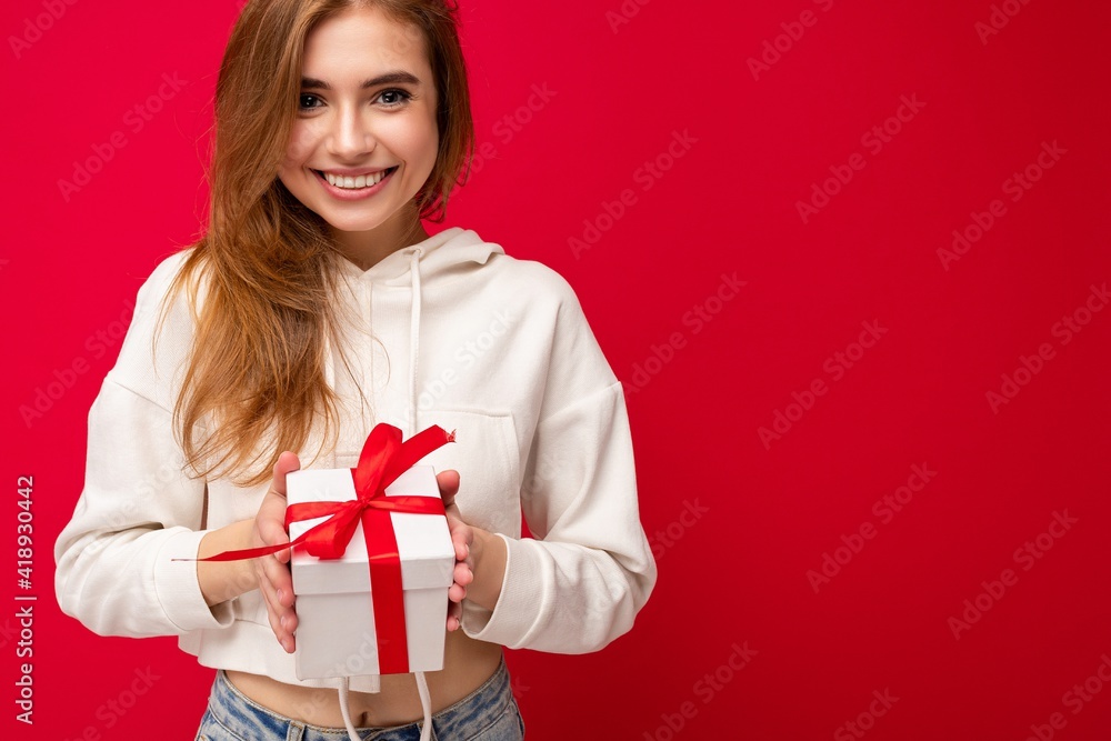 Wall mural photo shot of attractive happy smiling blonde young woman isolated over colorful background wall wea