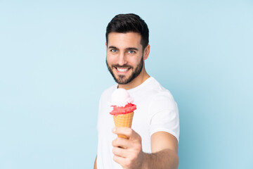 Caucasian man with a cornet ice cream isolated on blue background