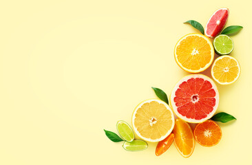 Creative composition of citrus fruits on yellow background