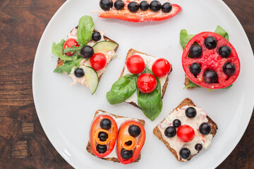 Lovely and tasty vegetarian sandwiches on a white plate from above