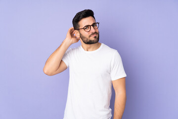 Caucasian handsome man over isolated background having doubts