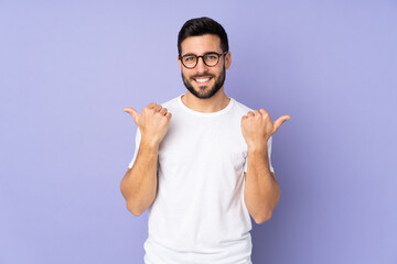 Caucasian handsome man over isolated background with thumbs up gesture and smiling