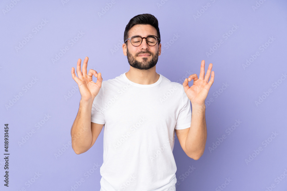 Sticker Caucasian handsome man over isolated background in zen pose