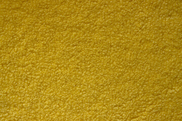 Yellow fluffy background. Texture of yellow twisted wool
