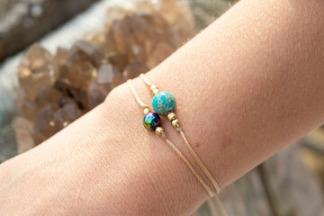 Female wrist wearing mineral stone beads tiny bracelets