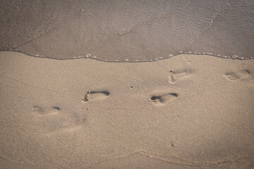 Fototapeta na wymiar child footprints on the beach sand