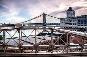 Naklejka premium The Brooklyn bridge in New York with the Manhattan skyline on the background.
