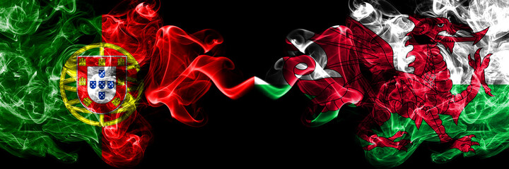 Portugal, Portuguese vs Wales, United Kingdom smoky mystic flags placed side by side. Thick colored silky abstract smoke flags.