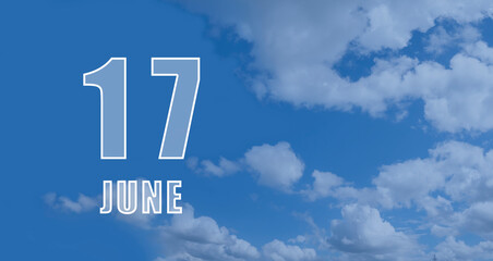 June 17. 17th day of the month, calendar date.White numbers against a blue sky with clouds. Copy space, Summer month, day of the year concept
