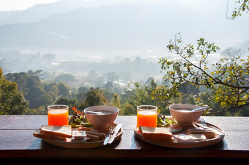 Breakfast serve on the table with Natural background.
