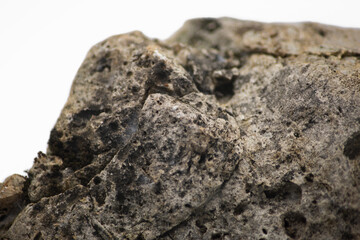 Close up view of a big gray stone with cobwebs and lichen isolated on white background. Macro photography. Horizontal shot