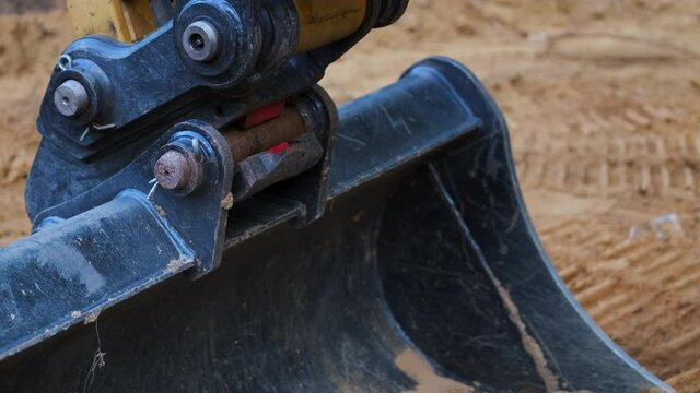 Close Up Pan of a Tilt Excavator Bucket 