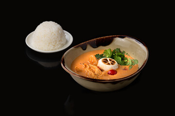 Spicy Thai soup Tom Yam on dark background