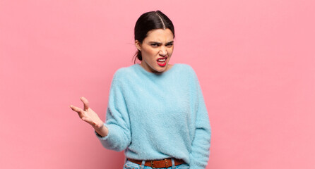 young pretty woman looking angry, annoyed and frustrated screaming wtf or what’s wrong with you