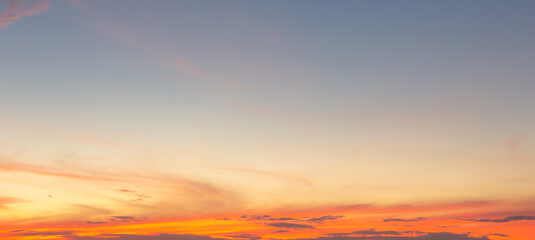 Beautiful Vivid sky painted by the sun leaving bright golden shades.Dense clouds in twilight sky in winter evening.Image of cloud sky on evening time.Evening Vivid sky with clouds.