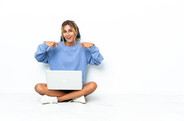 Young blonde Uruguayan girl with the laptop isolated on white background with surprise facial expression