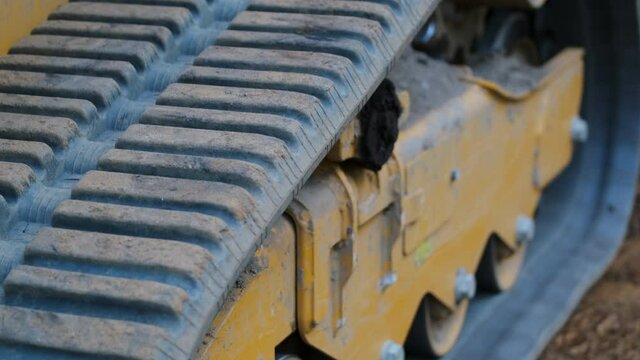 Close Up Tilt Down of Excavator Tracks