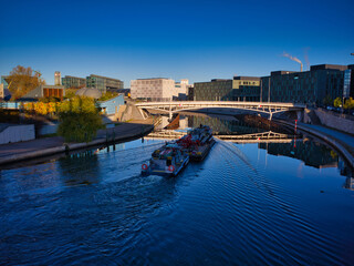 Looking at a boat on the Spree River with Berlin's main train station in the background.