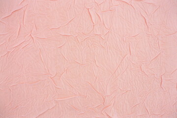 Light pink texture, gold-plated surface made of crumpled fabric. Crumpled, textured background with cracks and irregularities for decoration and design . Top view, copy space, flat lay.	
