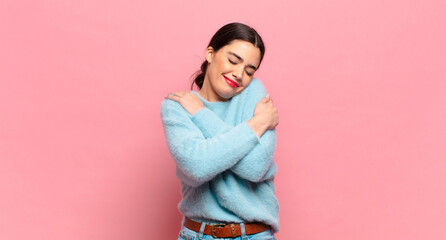 young pretty woman feeling in love, smiling, cuddling and hugging self, staying single, being...