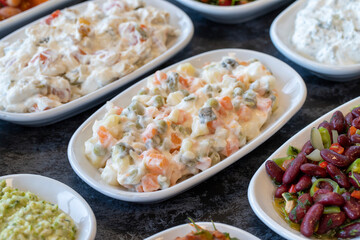 American salad. An aparatif meal prepared with potatoes, peas, pickles, corn and yogurt. Natural vegetarian food. Bulk appetizer plates American salad mezze