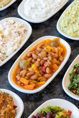 Kidney bean appetizer. Traditional Turkish and Arabic cuisine meze. Snack meal served alongside the main course.  Bulk mezze plates.  Natural vegetarian food. Barbunya plaki. Chili beans