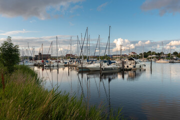 Fototapeta na wymiar Landscape with sailing yachts on the river Harle in Harlesiel