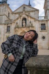 Fototapeta na wymiar Asian woman enjoying holidays as tourist in Europe - lifestyle portrait of young happy and beautiful Japanese girl in autumn coat touring the city relaxed and cheerful