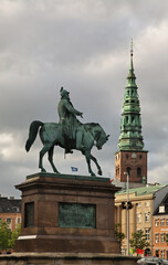 Fototapeta na wymiar Equestrian Statue of King Frederik VII and Saint Nicholas church in Copenhagen. Denmark