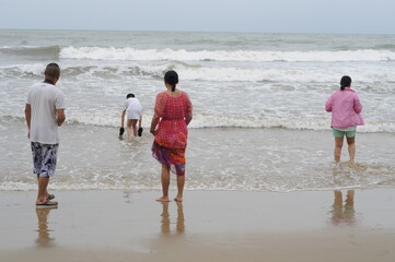 Asian tourists enjoy holiday at Tanjung Aru Beach in Kota Kinabalu, Malaysia.