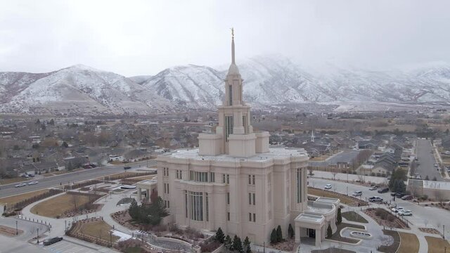 Beautiful aerial view of a Mormon Temple in Utah with hills covered in snow