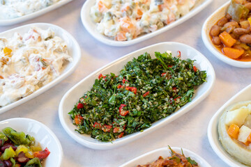Tabboule appetizer. Traditional Turkish and Arabic cuisine meze. Snack meal served alongside the main course. Natural vegetarian food. Local name taboule mezze. Bulk appetizer plates