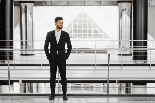 Modern building, pictured Indian businessman standing in the middle of a modern building, businessman holding