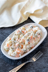 American salad. An aparatif meal prepared with potatoes, peas, pickles, corn and yogurt. Snack meal served alongside the main course. Natural vegetarian food. American salad mezze